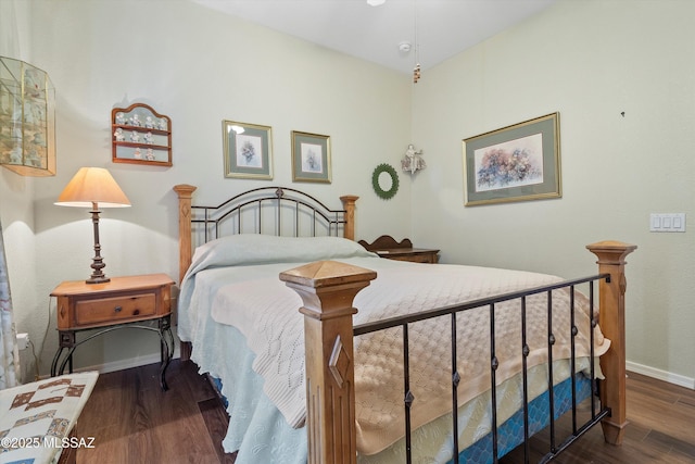 bedroom with dark hardwood / wood-style floors