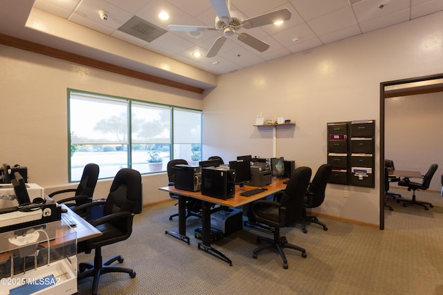 office space with a paneled ceiling, ceiling fan, and carpet floors