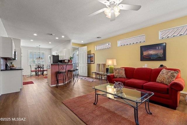 living room with hardwood / wood-style floors and ceiling fan