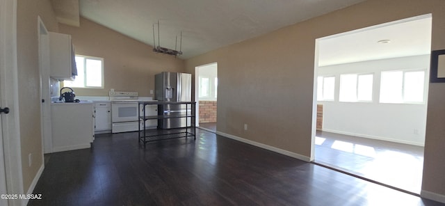 kitchen featuring white electric range oven, white cabinetry, stainless steel fridge with ice dispenser, and lofted ceiling