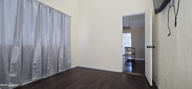 empty room featuring dark wood-type flooring