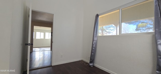 spare room featuring dark wood-type flooring