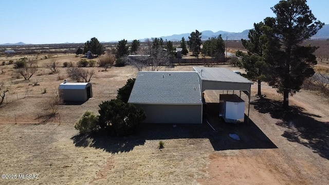 drone / aerial view with a mountain view and a rural view