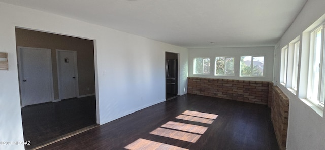 unfurnished room featuring dark hardwood / wood-style flooring