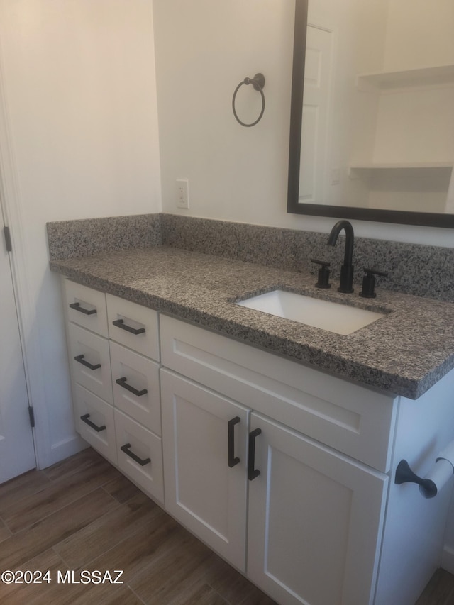 bathroom featuring vanity and hardwood / wood-style floors