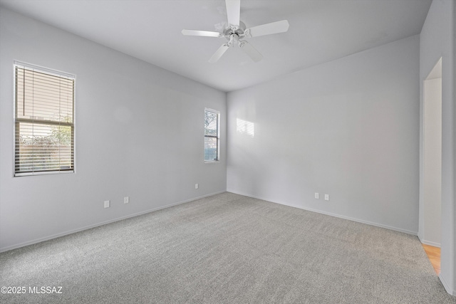 unfurnished room featuring light carpet and ceiling fan