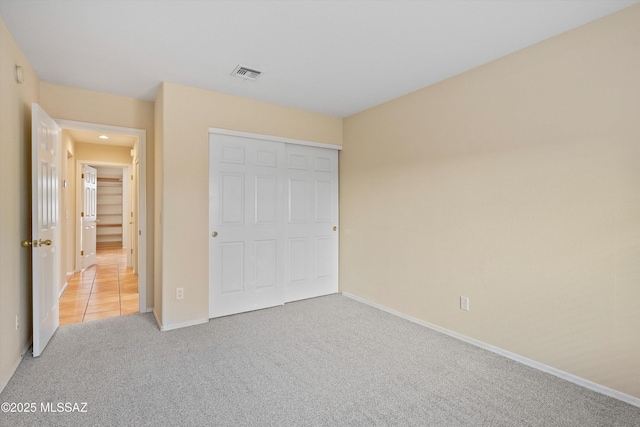 unfurnished bedroom with carpet and a closet