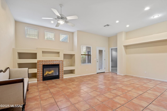 living room featuring a fireplace, light tile patterned floors, built in features, and ceiling fan