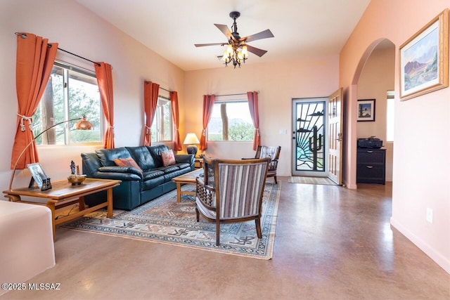 living room featuring concrete flooring and ceiling fan