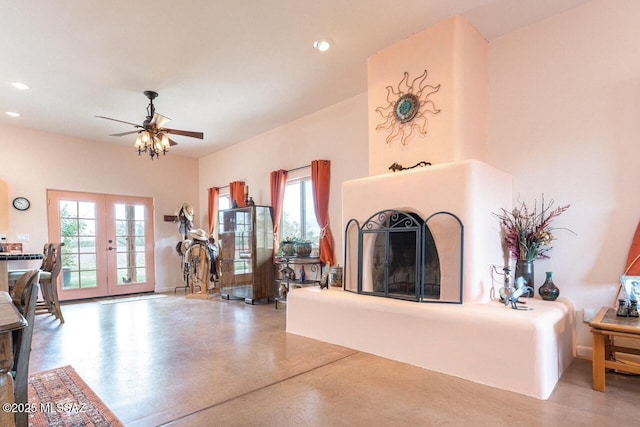 living room featuring ceiling fan and french doors