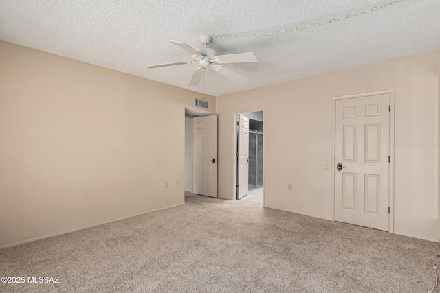 carpeted empty room featuring a textured ceiling and ceiling fan