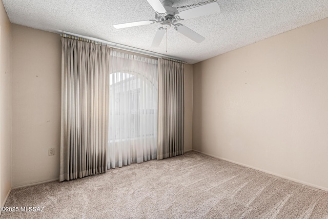 carpeted empty room with a textured ceiling and ceiling fan