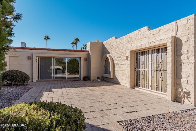 entrance to property featuring a patio