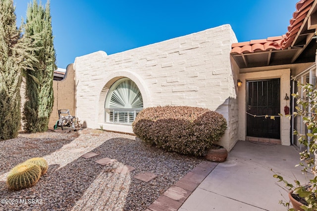 property entrance featuring a patio