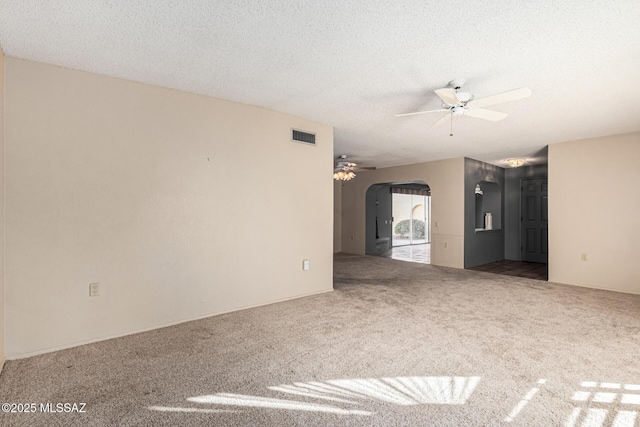 unfurnished living room with a textured ceiling, ceiling fan, and carpet floors