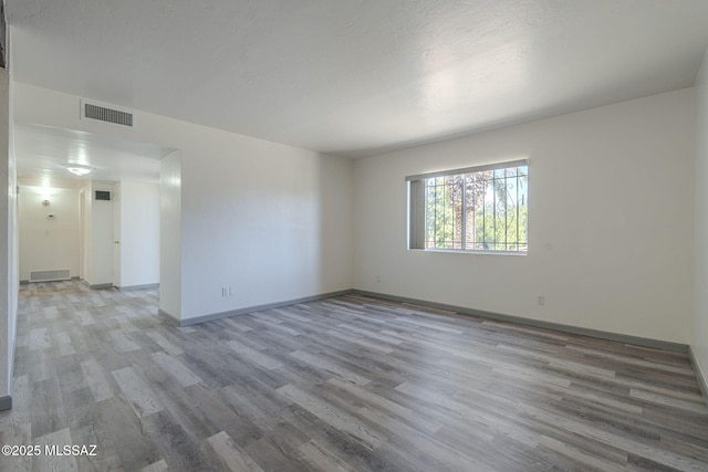 unfurnished room with light hardwood / wood-style flooring