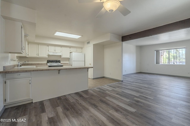 kitchen featuring white cabinetry, white refrigerator, electric stove, sink, and kitchen peninsula