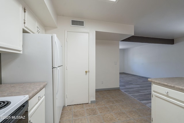 kitchen with white cabinets and white fridge