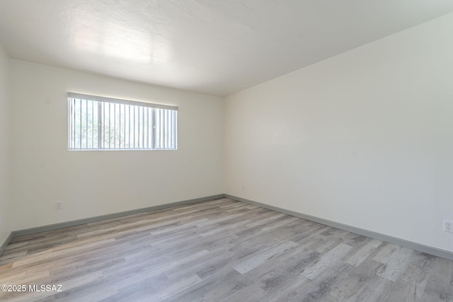 unfurnished room featuring light hardwood / wood-style floors