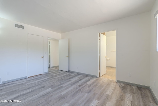 unfurnished bedroom featuring light wood-type flooring