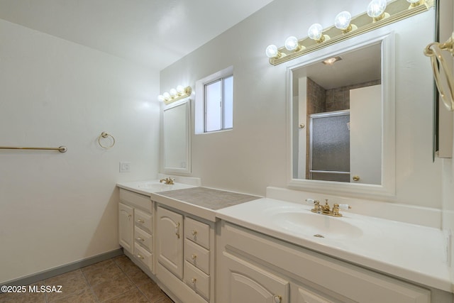 bathroom featuring tile patterned flooring, an enclosed shower, and vanity