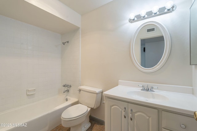 full bathroom featuring toilet, tiled shower / bath, and vanity