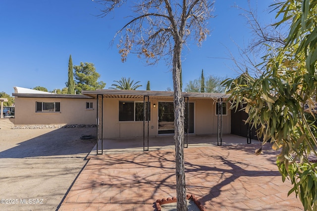 back of property featuring a patio