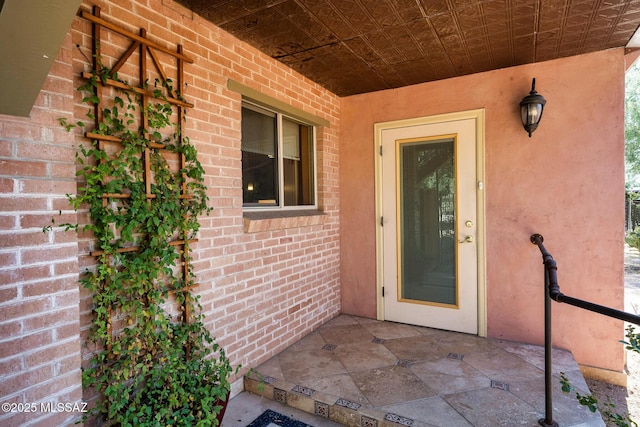 property entrance featuring a patio area