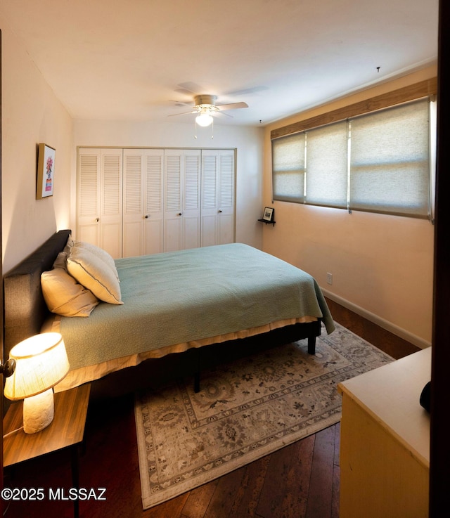 bedroom with dark hardwood / wood-style flooring, a closet, and ceiling fan