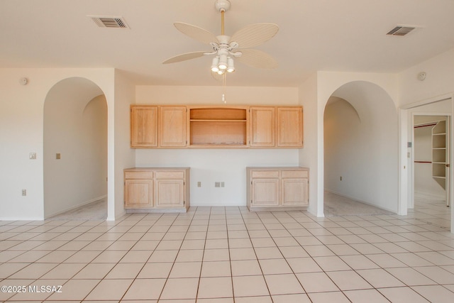 kitchen with ceiling fan, light brown cabinets, and light tile patterned floors