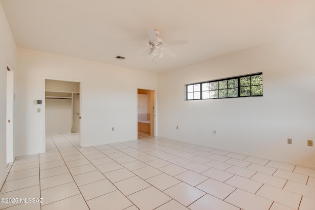 unfurnished room featuring light tile patterned floors and ceiling fan