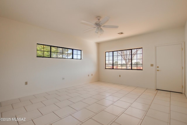 unfurnished room featuring ceiling fan and light tile patterned flooring