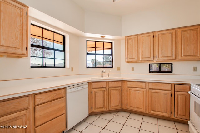 kitchen with dishwasher, light tile patterned floors, sink, and light brown cabinetry