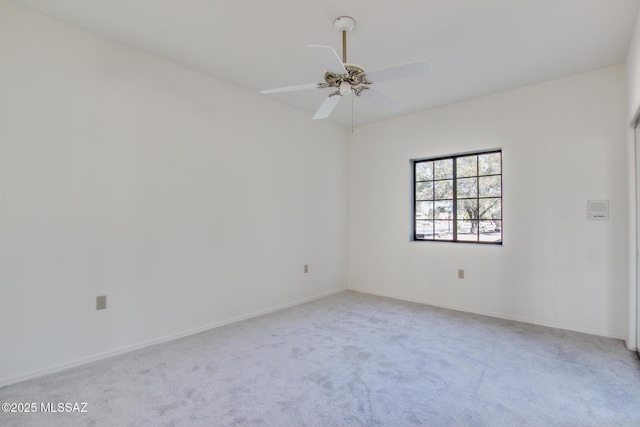 spare room with ceiling fan and light carpet