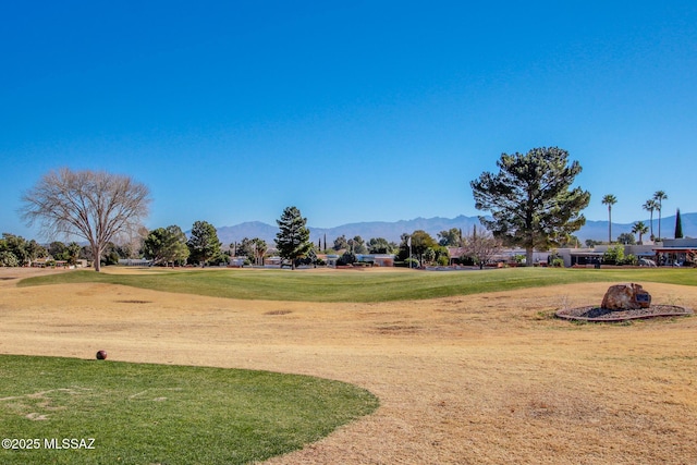 surrounding community featuring a mountain view and a lawn