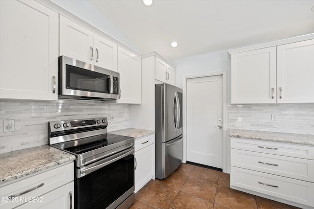 kitchen with white cabinetry, stainless steel appliances, and tasteful backsplash