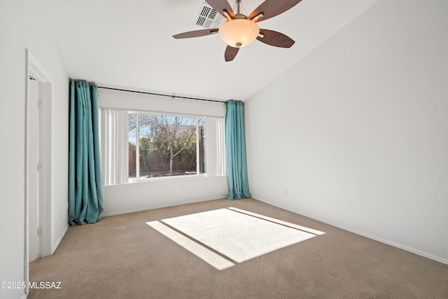 carpeted spare room with ceiling fan and lofted ceiling