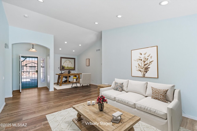 living room featuring wood-type flooring and lofted ceiling