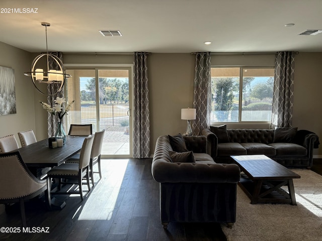 living room with a chandelier and dark hardwood / wood-style flooring