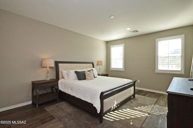 bedroom with dark hardwood / wood-style floors