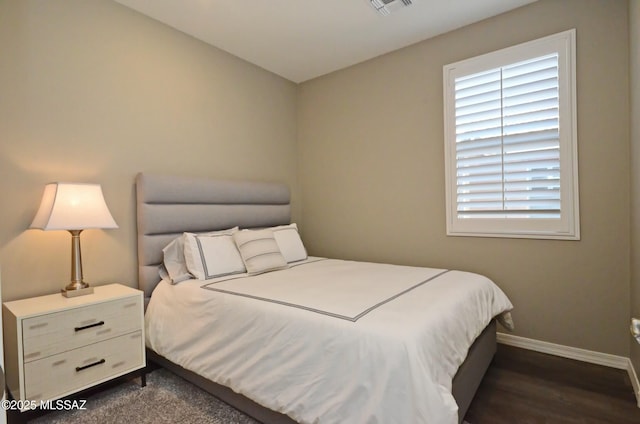 bedroom featuring dark hardwood / wood-style flooring