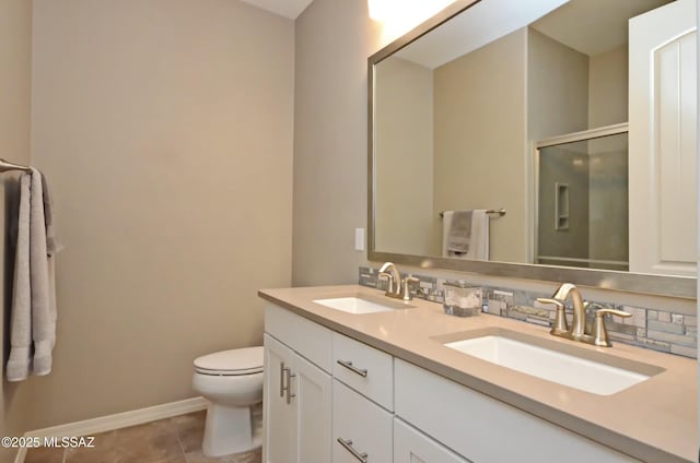 bathroom with toilet, tile patterned flooring, walk in shower, and vanity