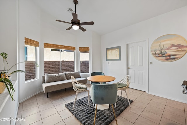 dining space with ceiling fan and light tile patterned flooring