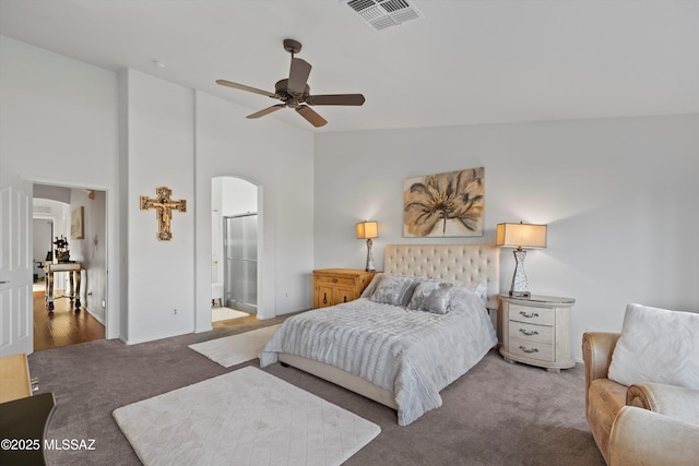 carpeted bedroom with ceiling fan, connected bathroom, and lofted ceiling