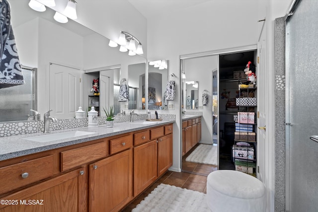 bathroom featuring an enclosed shower, vanity, and tile patterned flooring