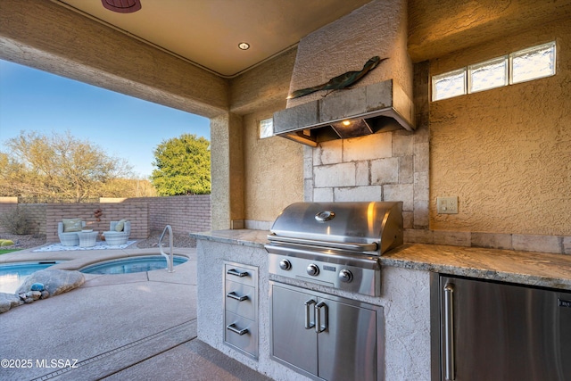 view of patio / terrace with an outdoor kitchen, a fenced in pool, and area for grilling