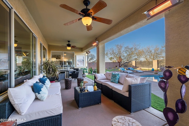 patio terrace at dusk featuring a fenced in pool, outdoor lounge area, and ceiling fan