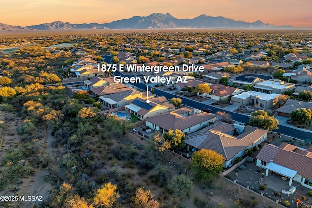 aerial view at dusk featuring a mountain view