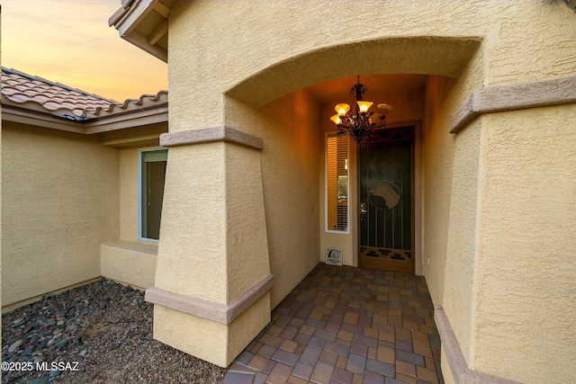 view of exterior entry at dusk