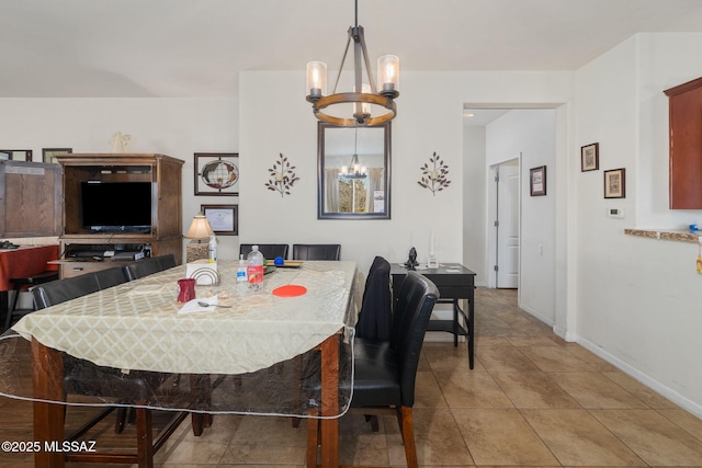 tiled dining room featuring a notable chandelier